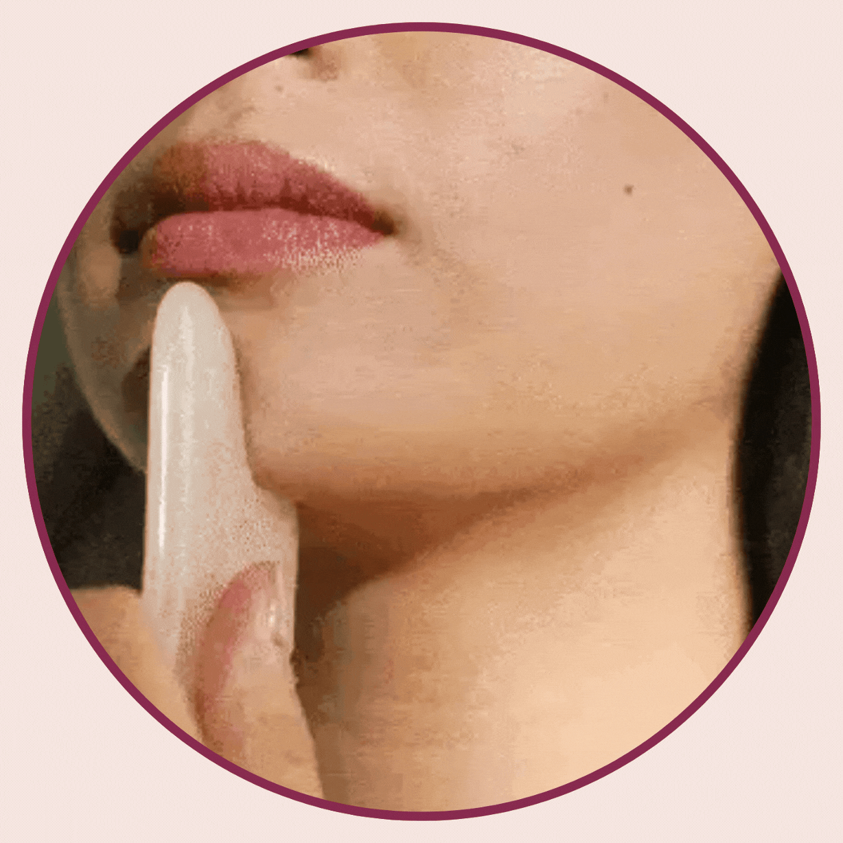 A woman using the GlowSculpt™ Gua Sha Stone LLUCCI product on her jawline